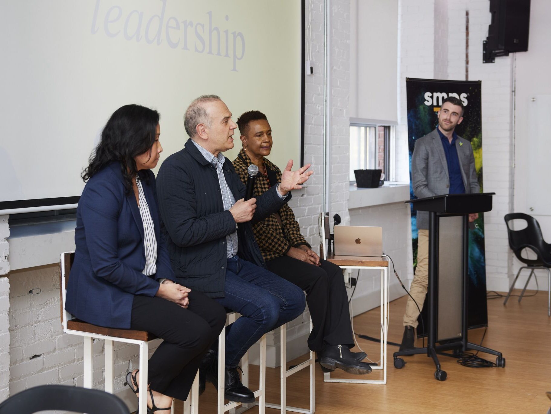 Cynthia, Ian and Sybil discussing change management in a panel discussion moderated by Russell.